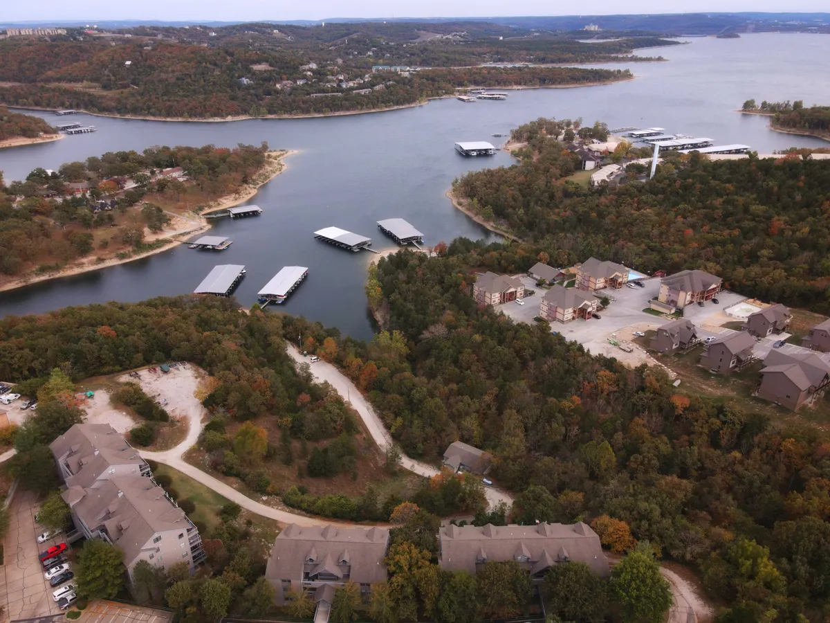 A panoramic view of serene water bodies and marinas nestled among leafy surroundings and residential buildings. The peaceful setting illustrates outdoor opportunities like boating, fishing, lakeside strolls, and wildlife watching, with a subtle nod to the proximity of top attractions.